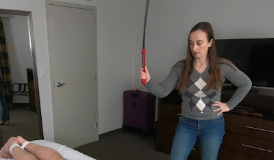 Miss Jenn Davis using the sjambok on spankee