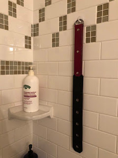 leather strap in the bathroom belonging to Professional Disciplinarian