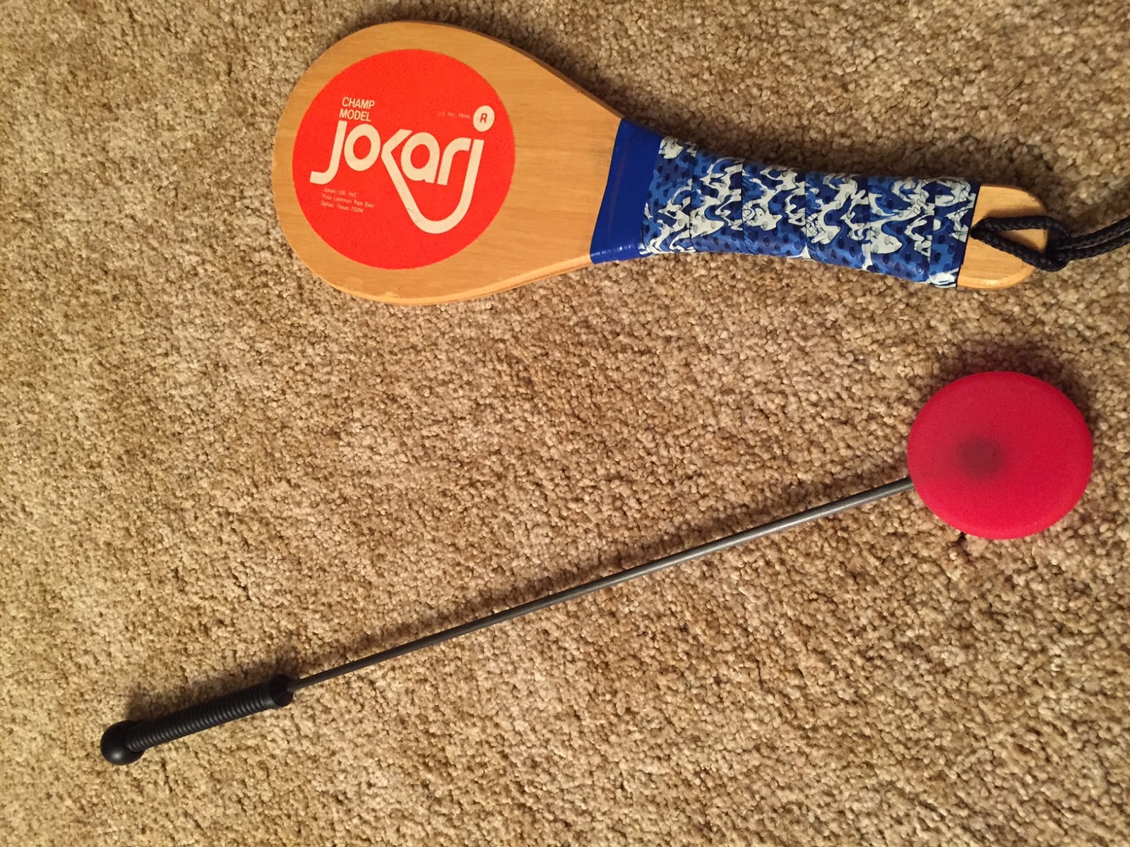 Jokari paddle and red lollipop paddle