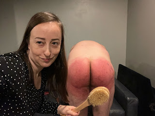 Miss Jenn Davis gives a bathbrush spanking