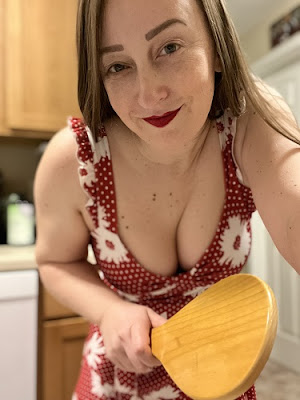 Miss Jenn Davis holding a spanking paddle