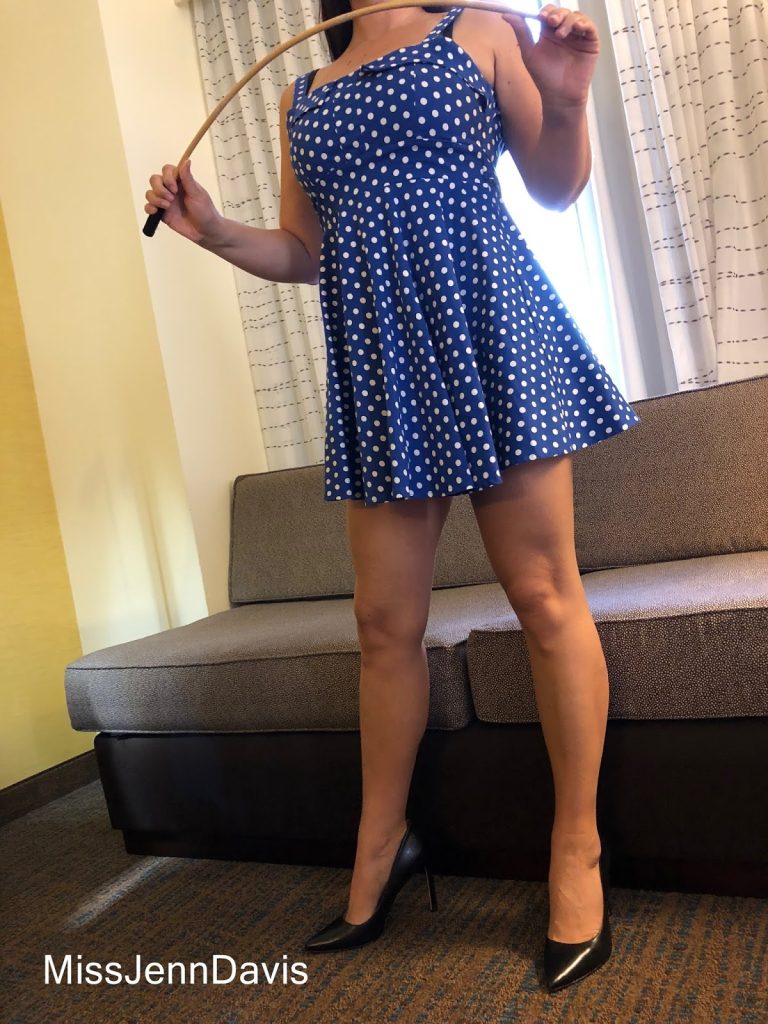 caning, Seattle spanker, Seattle spanking, professional disciplinarian Miss Jenn Davis holding a cane, Seattle Dominatrix