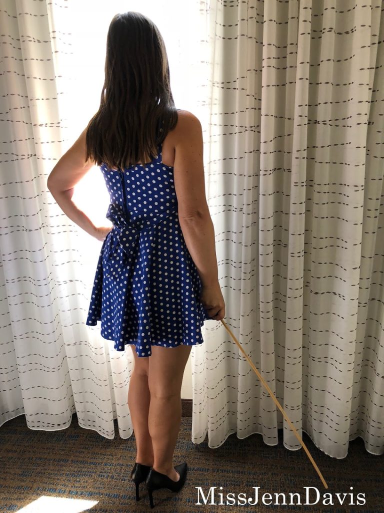 Seattle spanker, Seattle spanking, professional disciplinarian Miss Jenn Davis holding a cane, caning, Seattle Domme