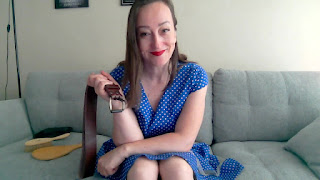 Professional Disciplinarian Miss Jenn Davis holding the belt