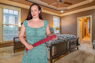 woman holding a spanking strap