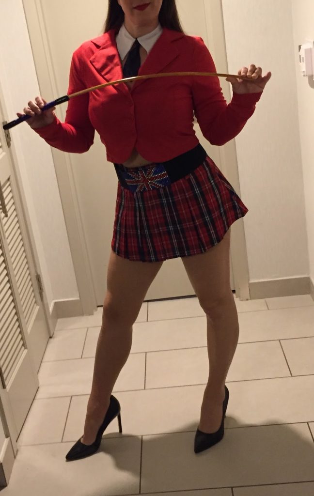 Seattle spanker, Seattle spanking, professional disciplinarian Miss Jenn Davis holding a cane