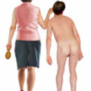 Woman taking naughty boy by the ear while holding a hairbrush