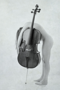 Fine art nude. Seattle art model Miss Jenn laying nude over the cello